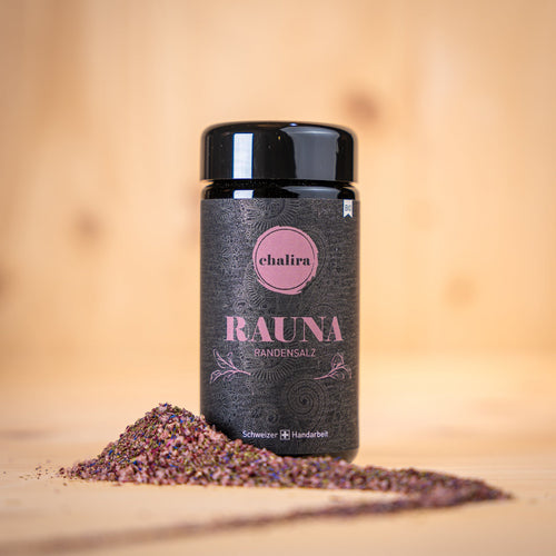 RAUNA Randensalz BIO Gewürz in schwarzem Glasbehälter mit bunter Gewürzmischung auf Holzuntergrund.